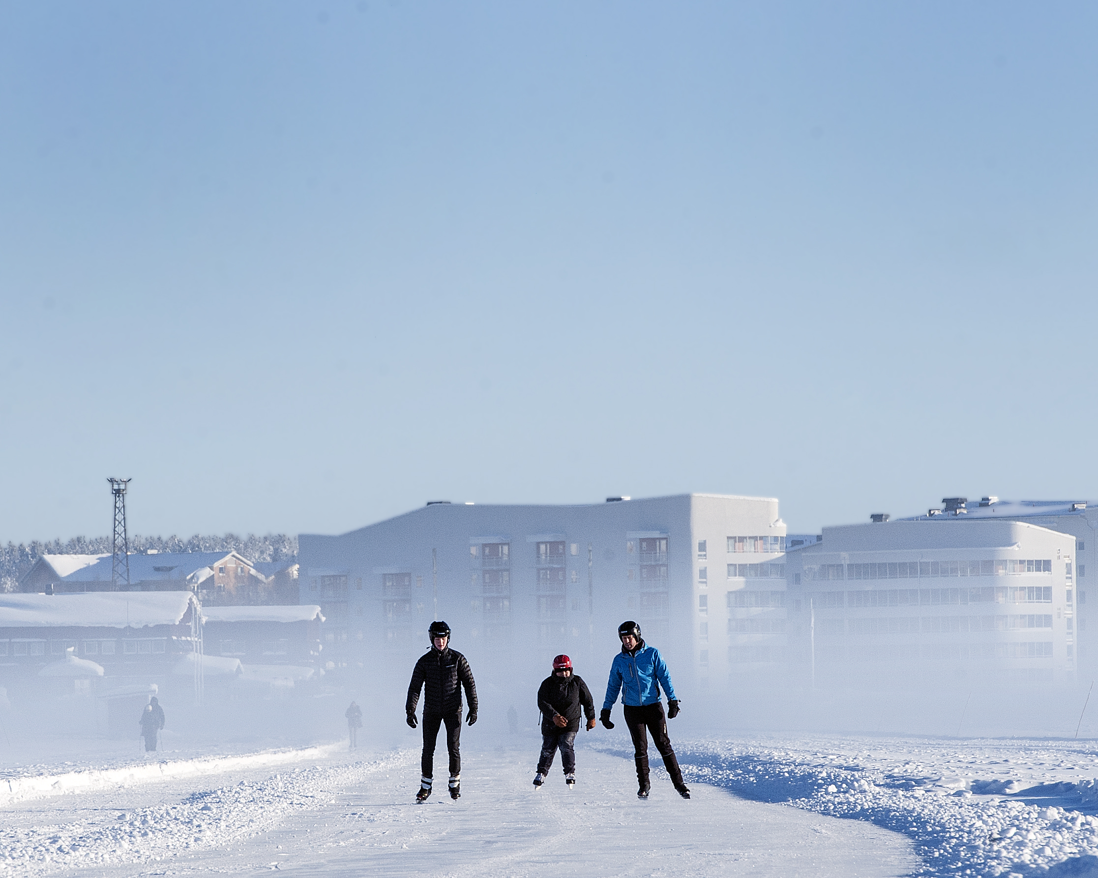 People skating on the ice track in Luleå