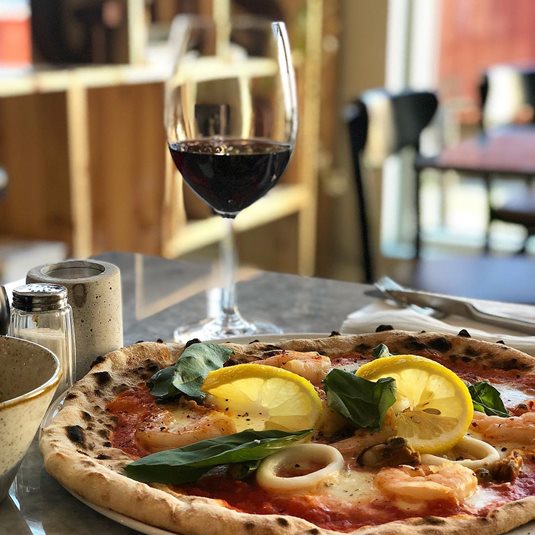 Pizza and red wine at Taverna Gusto